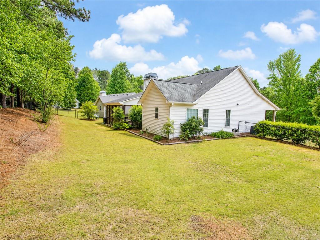 205 Richmond Hill Road Monroe, GA 30655 - Photo 4 of 15 a view of an house with pool and trees in the background