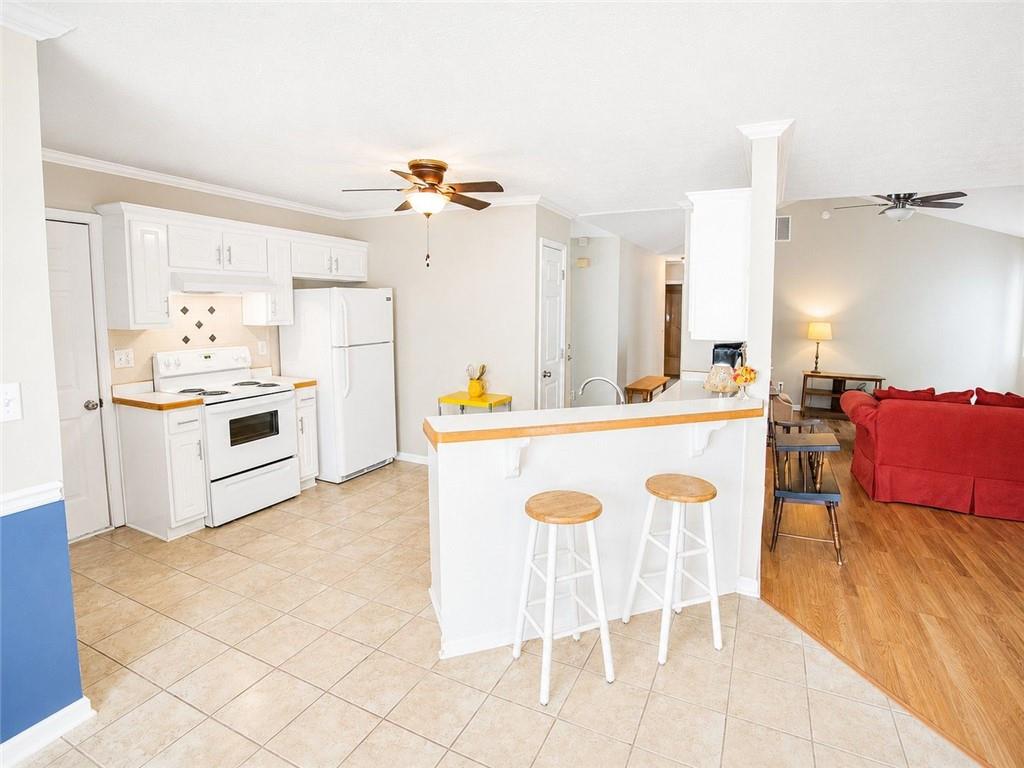 205 Richmond Hill Road Monroe, GA 30655 - Photo 8 of 15 a kitchen with a dining table chairs and white appliances