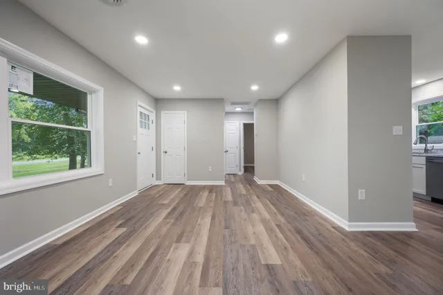 a view of empty room with wooden floor