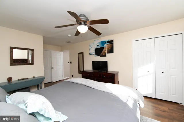 a bathroom with a sink a toilet a mirror and shower