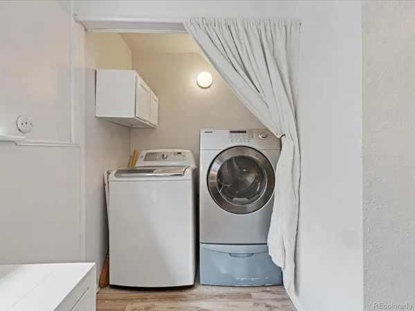 a utility room with sink dryer and washer