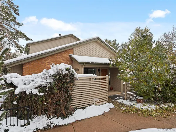 a front view of a house with a tree
