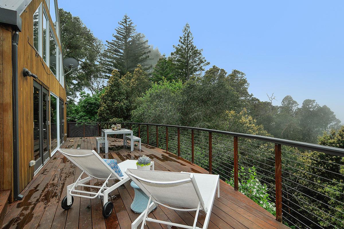 214 Swett Road Woodside, CA 94062 - Photo 42 of 67 a balcony of a house with wooden floor outdoor seating and yard in the back