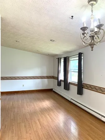 a view of room with window and hardwood floor
