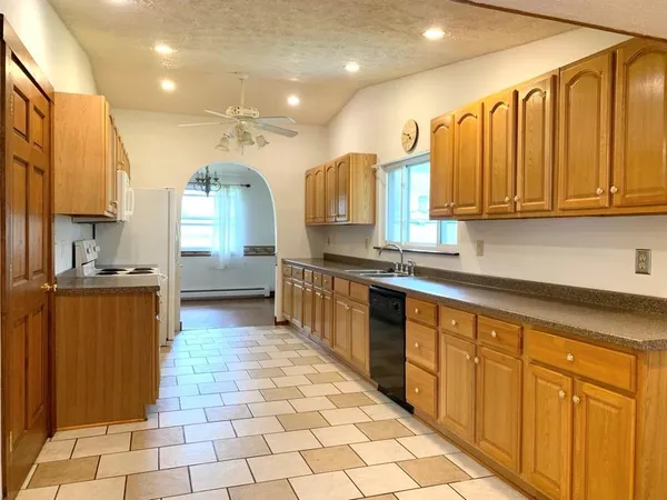 a kitchen with stainless steel appliances a sink cabinets and a counter top space