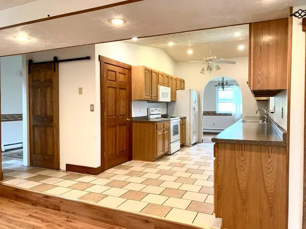 a kitchen with stainless steel appliances granite countertop a refrigerator and a sink
