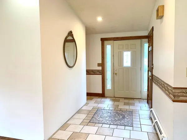 a view of a room with wooden floor and white walls
