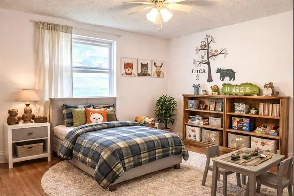a bedroom with a bed a table and a bookshelf