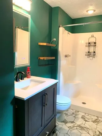 a bathroom with a sink toilet and shower