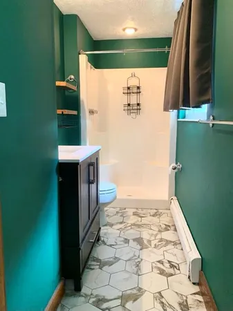 a view of an empty room with a sink and a window