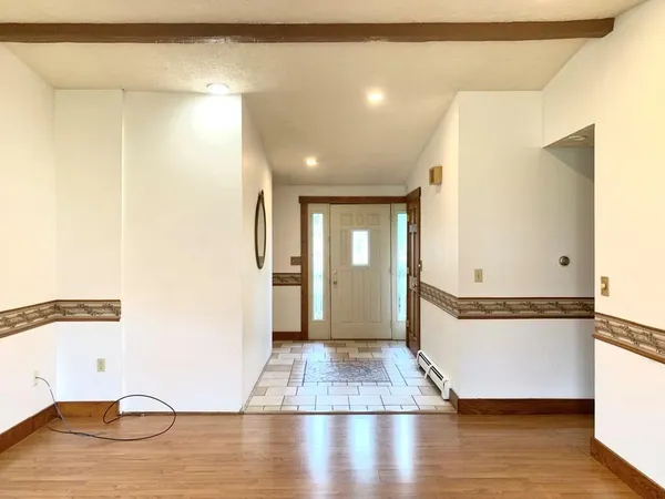 a view of a room with wooden floor