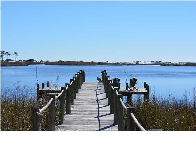 Lot 13 Wilderness Way Santa Rosa Beach, FL 32459 - Photo 1 of 4 a view of a balcony with chairs and wooden floor