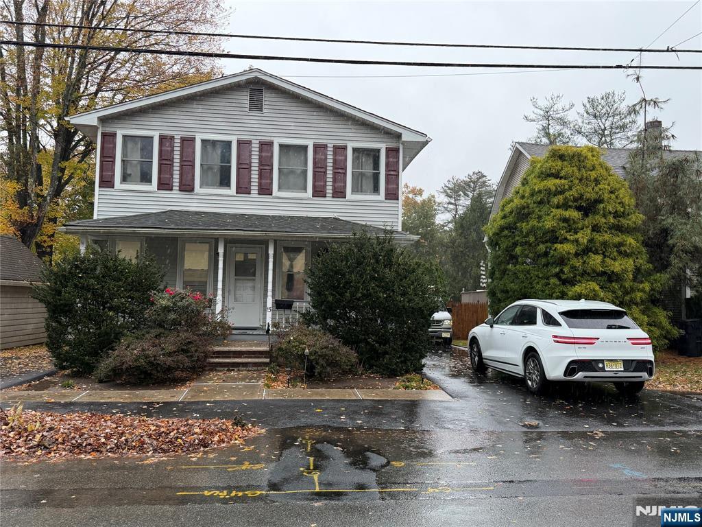 a white car parked in front of a house