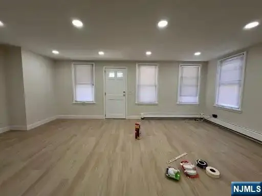 a kitchen with stainless steel appliances granite countertop a refrigerator a stove a sink dishwasher and a refrigerator with wooden floor