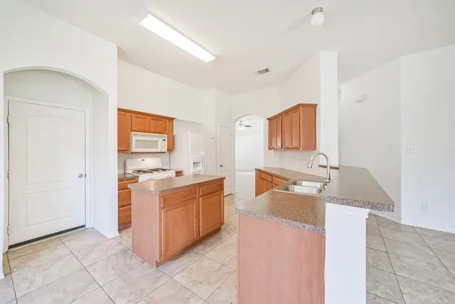a kitchen with stainless steel appliances granite countertop a stove and a refrigerator
