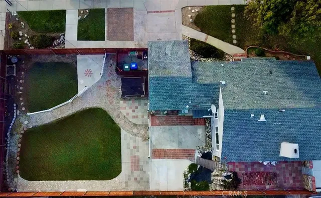 an aerial view of a house with a yard