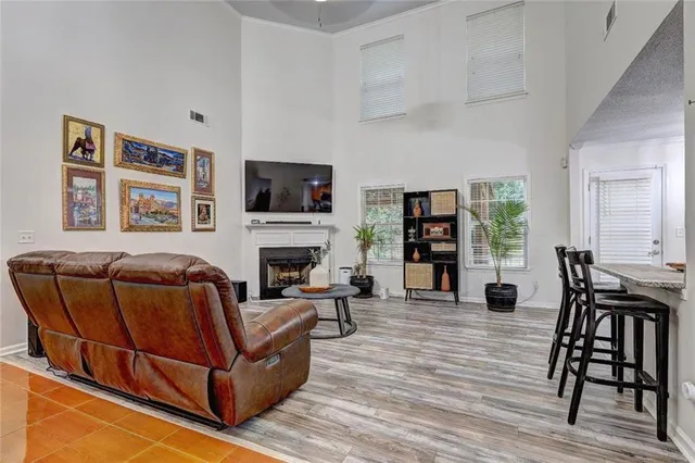 a view of a dining room and livingroom with furniture wooden floor and a clock