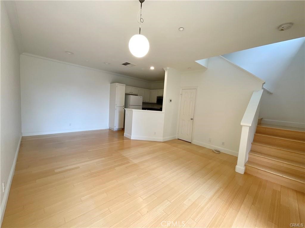 511 Birch Grove Irvine, CA 92618 - Photo 8 of 15 a view of a room with wooden floor and stairs