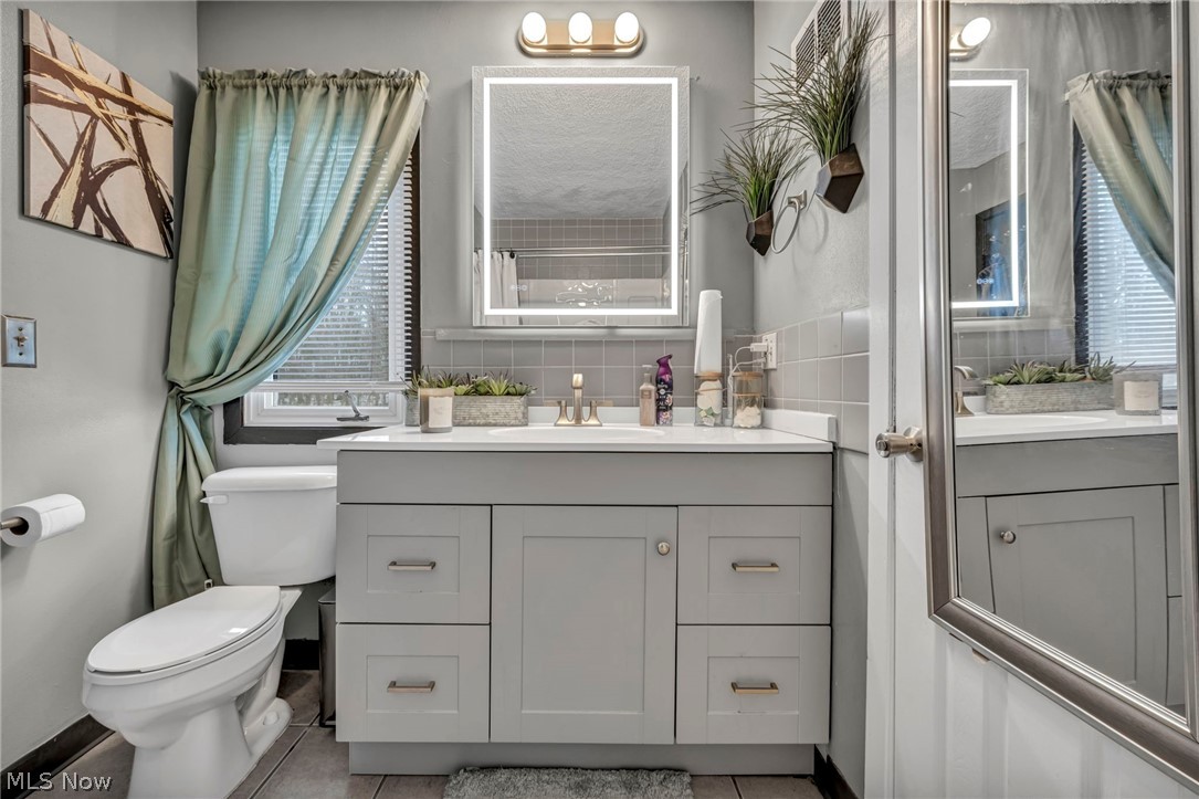 13800 Milo Road Garfield Heights, OH 44125 - Photo 21 of 39 Full bathroom featuring vanity and light tile patterned floors