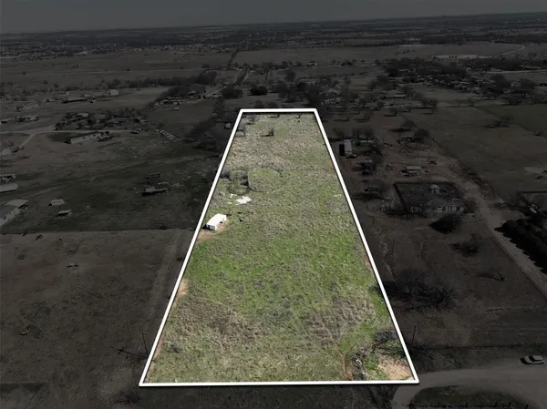 a view of a big yard with wooden fence