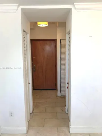 a view of a small space with a wooden door