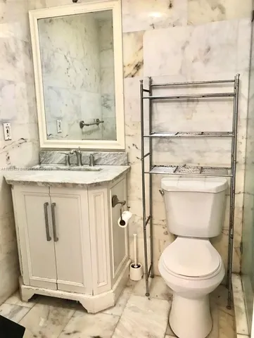 a bathroom with a toilet sink and shower