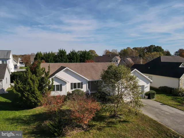 a aerial view of a house next to a yard