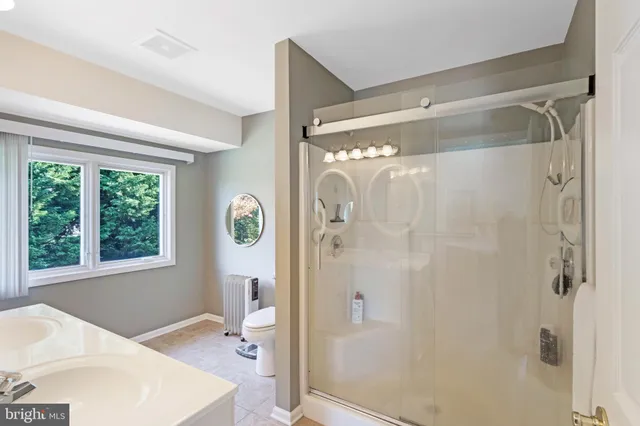 a bathroom with a bathtub a sink and a shower