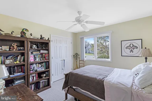 a bedroom with a bed and a book shelf