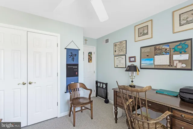 a view of a workspace with furniture and cabinet