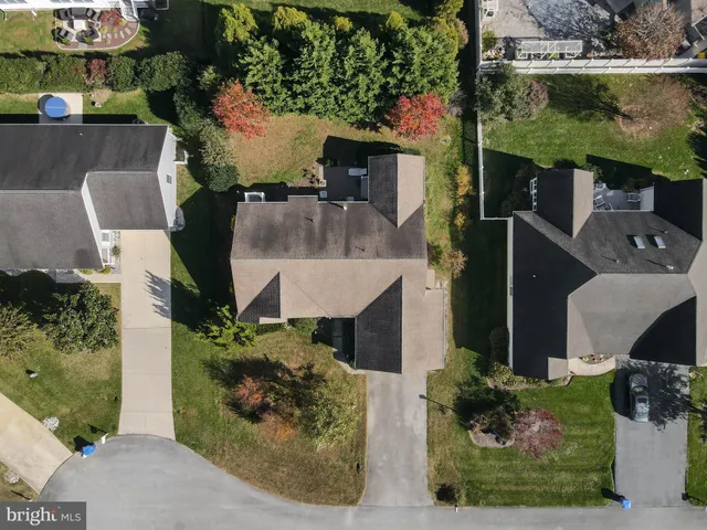 an aerial view of a house with a yard basket ball court and outdoor seating