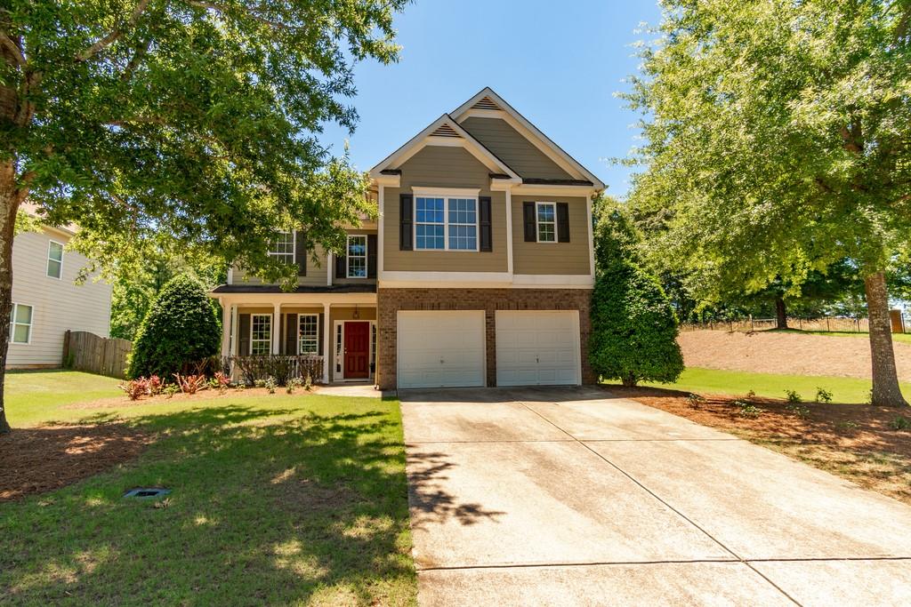 187 Mill Creek Drive Canton, GA 30115 - Photo 1 of 1 a front view of a house with a yard and trees
