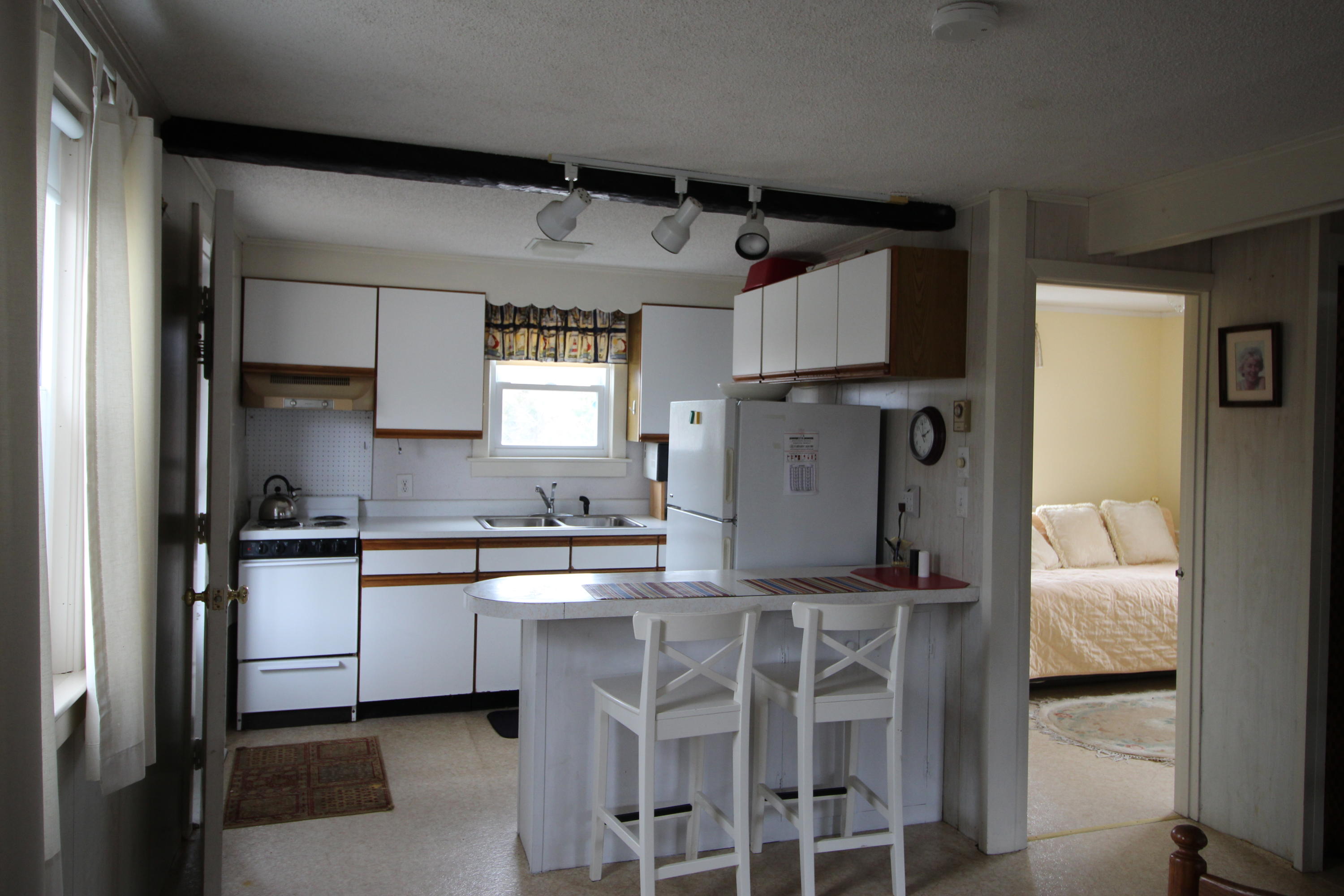 21 Knowles Heights Road Truro, MA 02666 - Photo 11 of 38 a kitchen with stainless steel appliances granite countertop a sink and cabinets