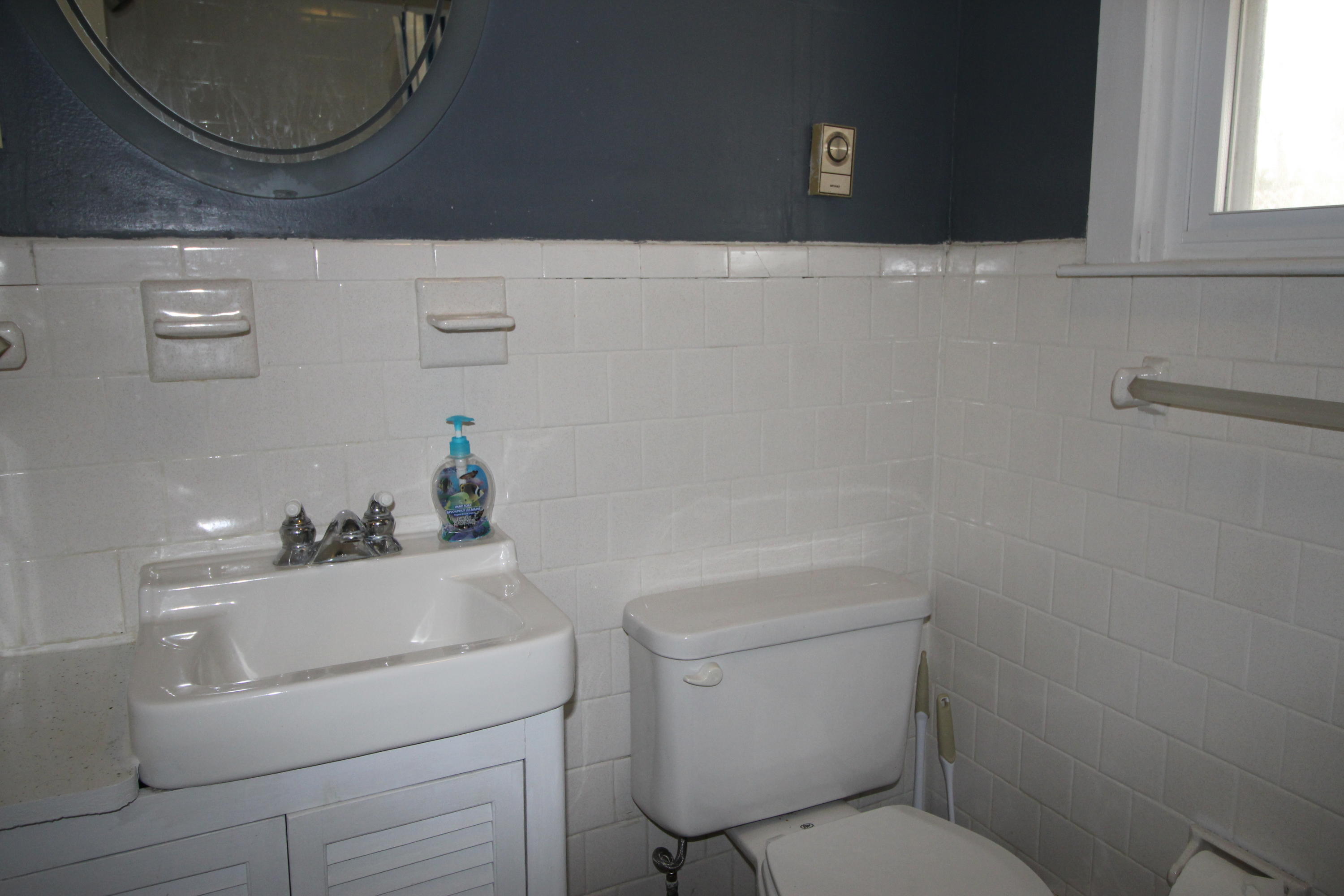21 Knowles Heights Road Truro, MA 02666 - Photo 33 of 38 a bathroom with a sink a toilet and a mirror