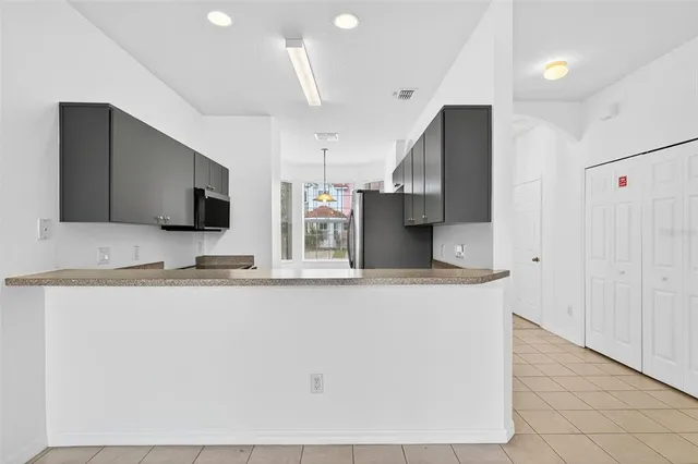 a kitchen with a sink stove and microwave