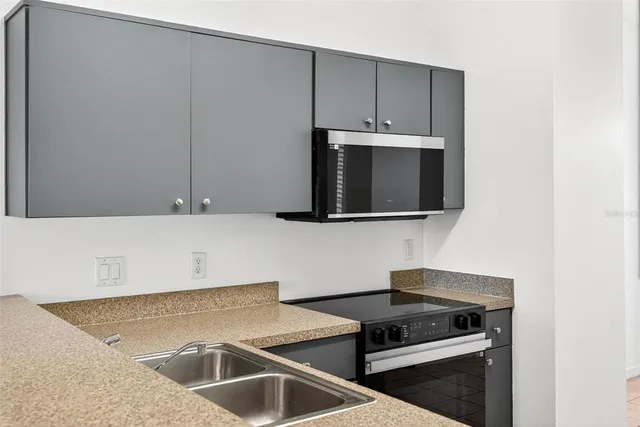 a kitchen with a sink and cabinets