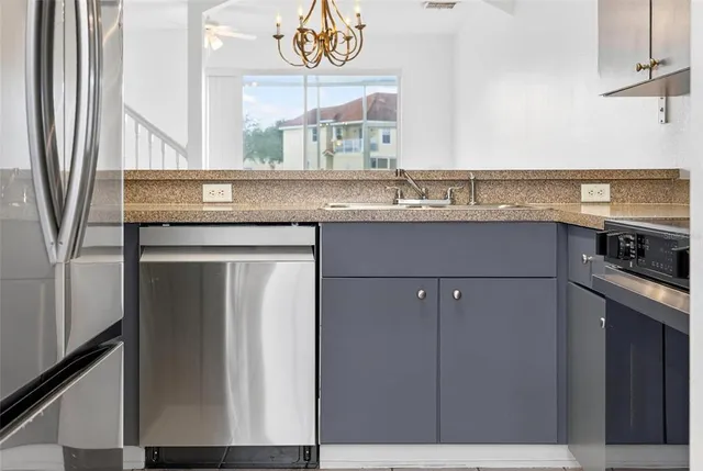 a kitchen with a refrigerator and a sink