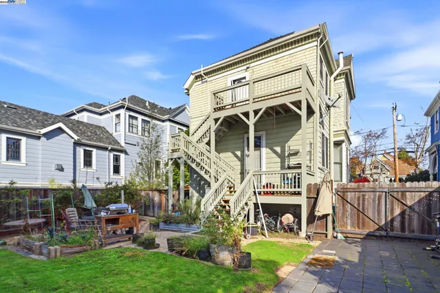 a view of a brick house with a yard patio and fire pit