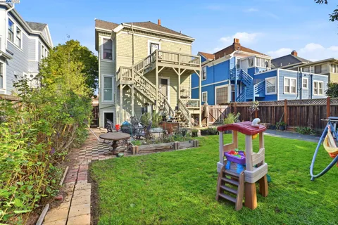 a view of a backyard with table and chairs and a fire pit