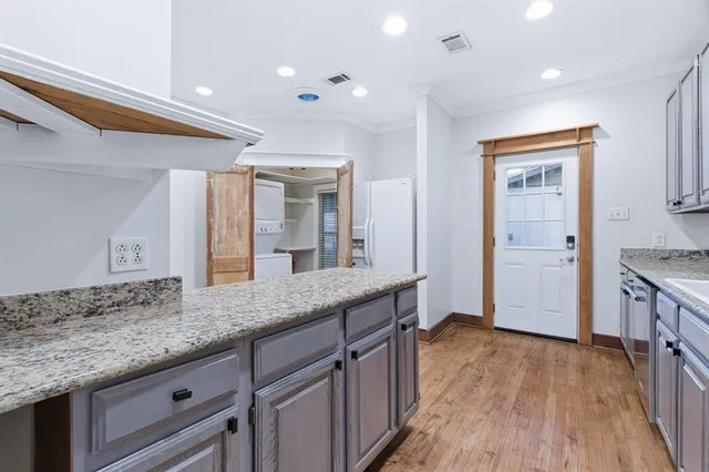 a spacious bathroom with a granite countertop sink a mirror and shower