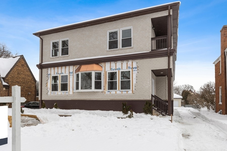 33 Northgate Road Riverside, IL 60546 - Photo 1 of 28 a front view of a house with a yard covered in snow