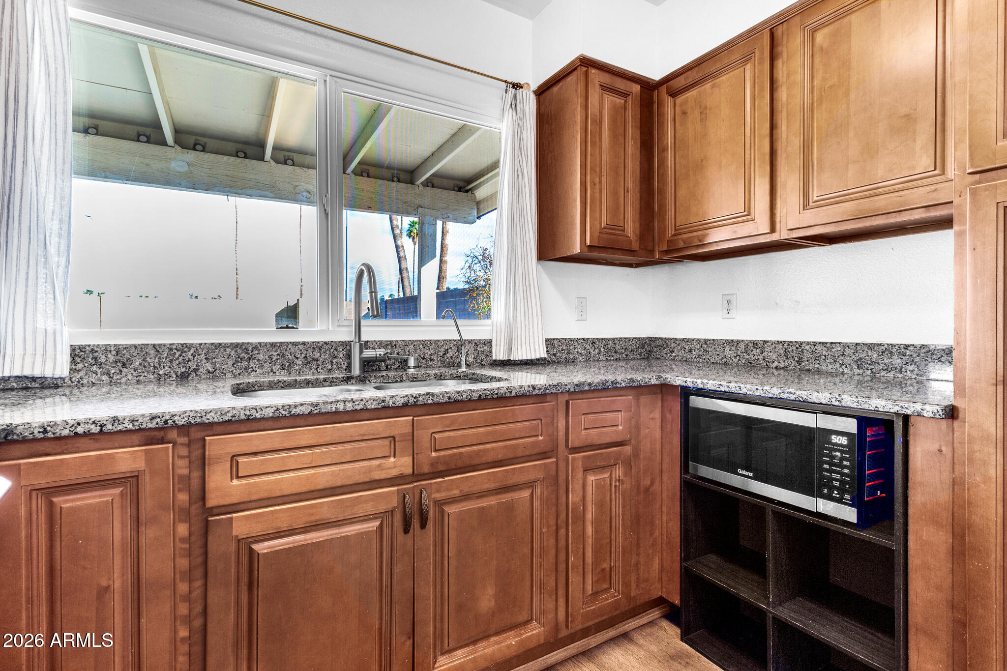 2024 East Rice Drive Tempe, AZ 85283 - Photo 13 of 39 a kitchen with stainless steel appliances granite countertop a sink and a microwave