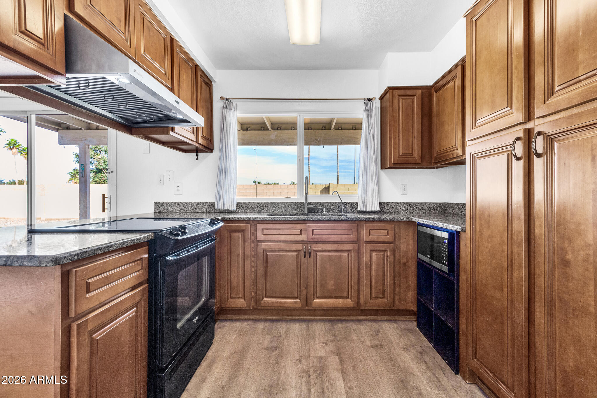 2024 East Rice Drive Tempe, AZ 85283 - Photo 14 of 39 a kitchen with stainless steel appliances granite countertop a stove a sink and a refrigerator