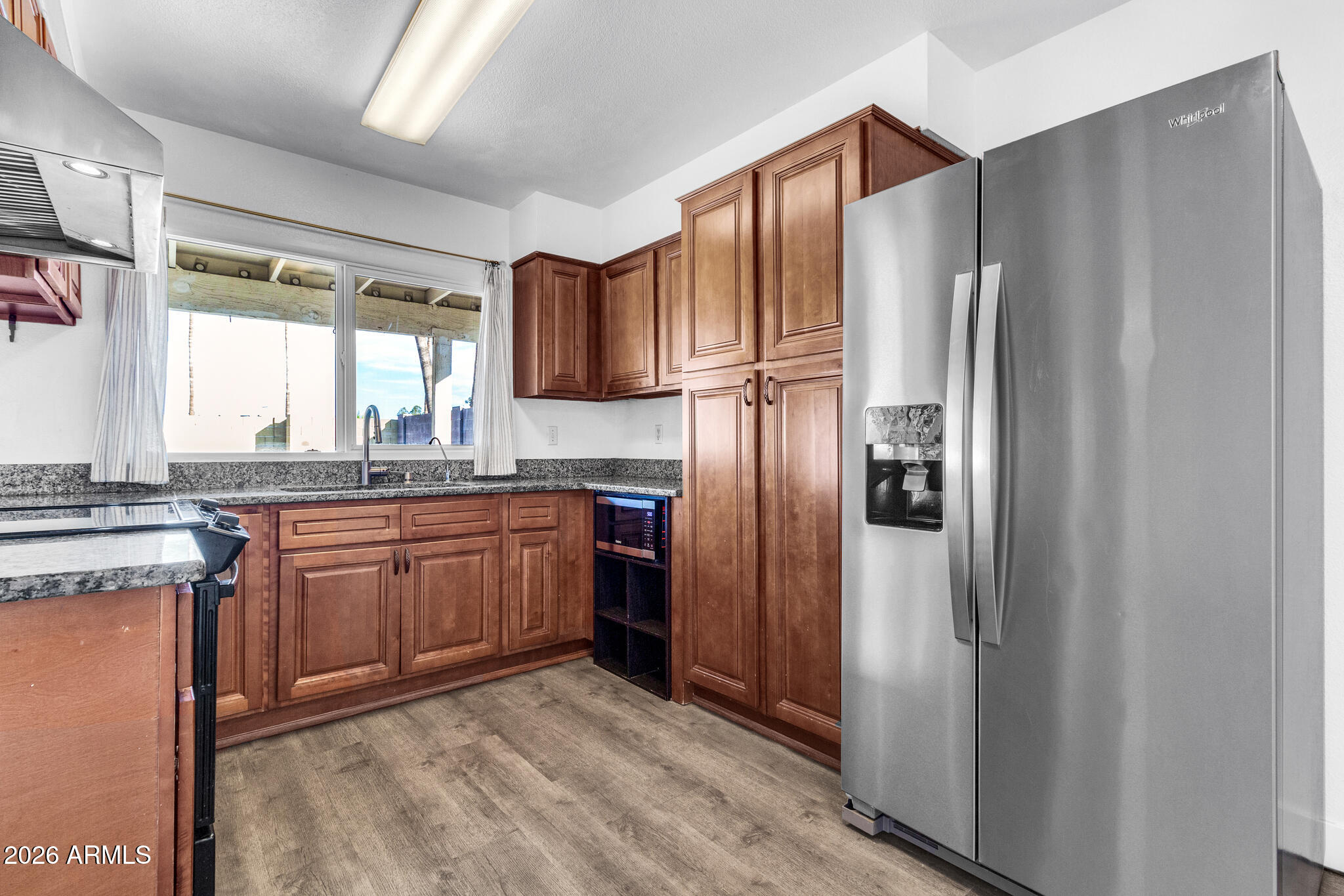 2024 East Rice Drive Tempe, AZ 85283 - Photo 17 of 39 a kitchen with stainless steel appliances granite countertop a refrigerator a sink a stove a washer dryer and a refrigerator