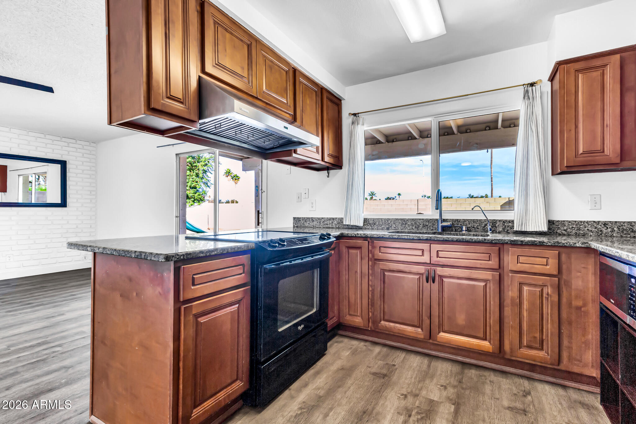 2024 East Rice Drive Tempe, AZ 85283 - Photo 18 of 39 a kitchen with stainless steel appliances granite countertop a stove a sink and a microwave