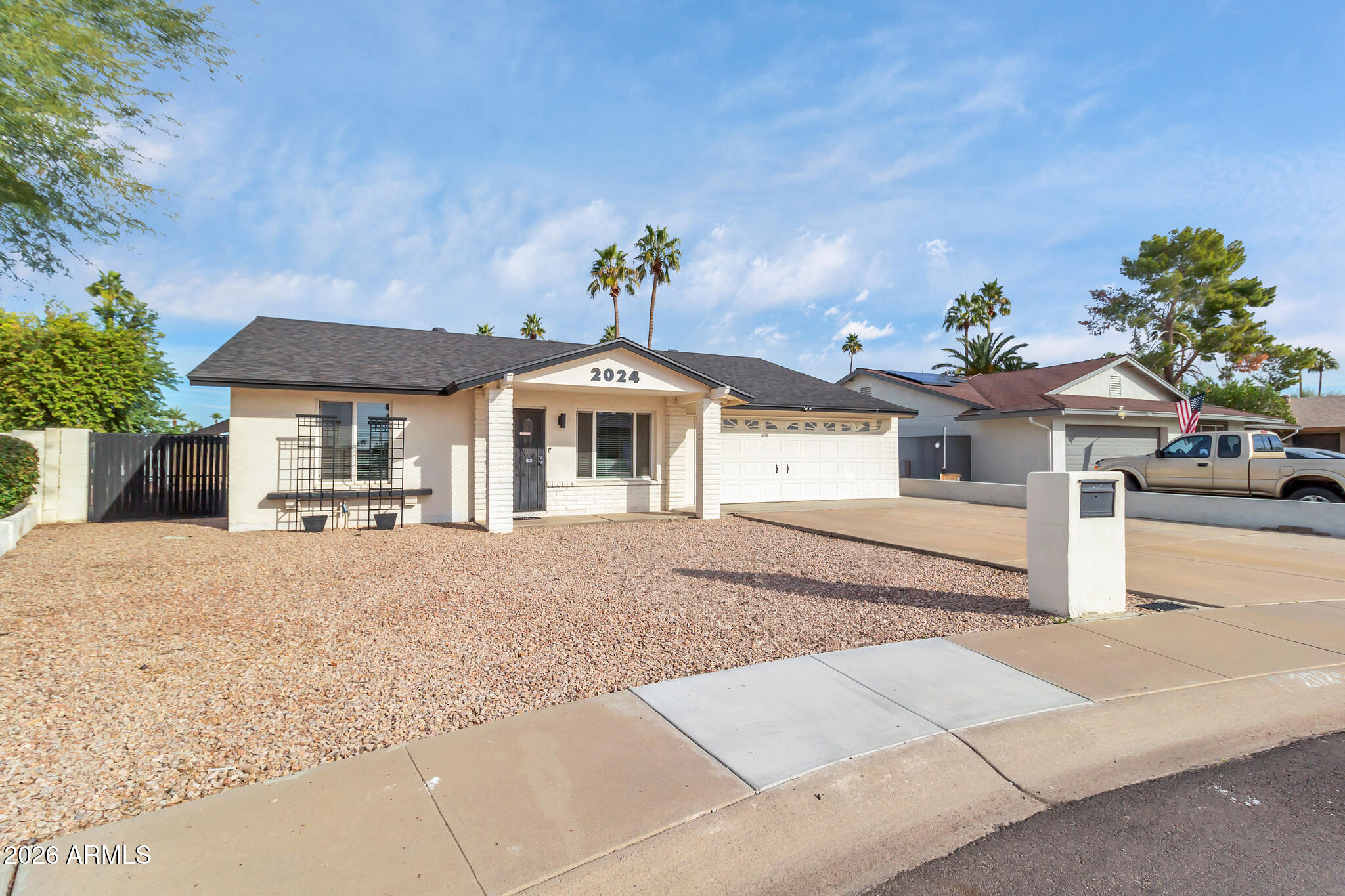 2024 East Rice Drive Tempe, AZ 85283 - Photo 2 of 39 a front view of a house with a yard and garage