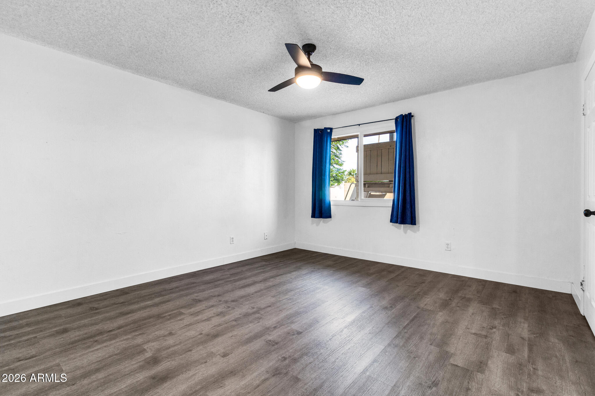 2024 East Rice Drive Tempe, AZ 85283 - Photo 23 of 39 an empty room with wooden floor and windows