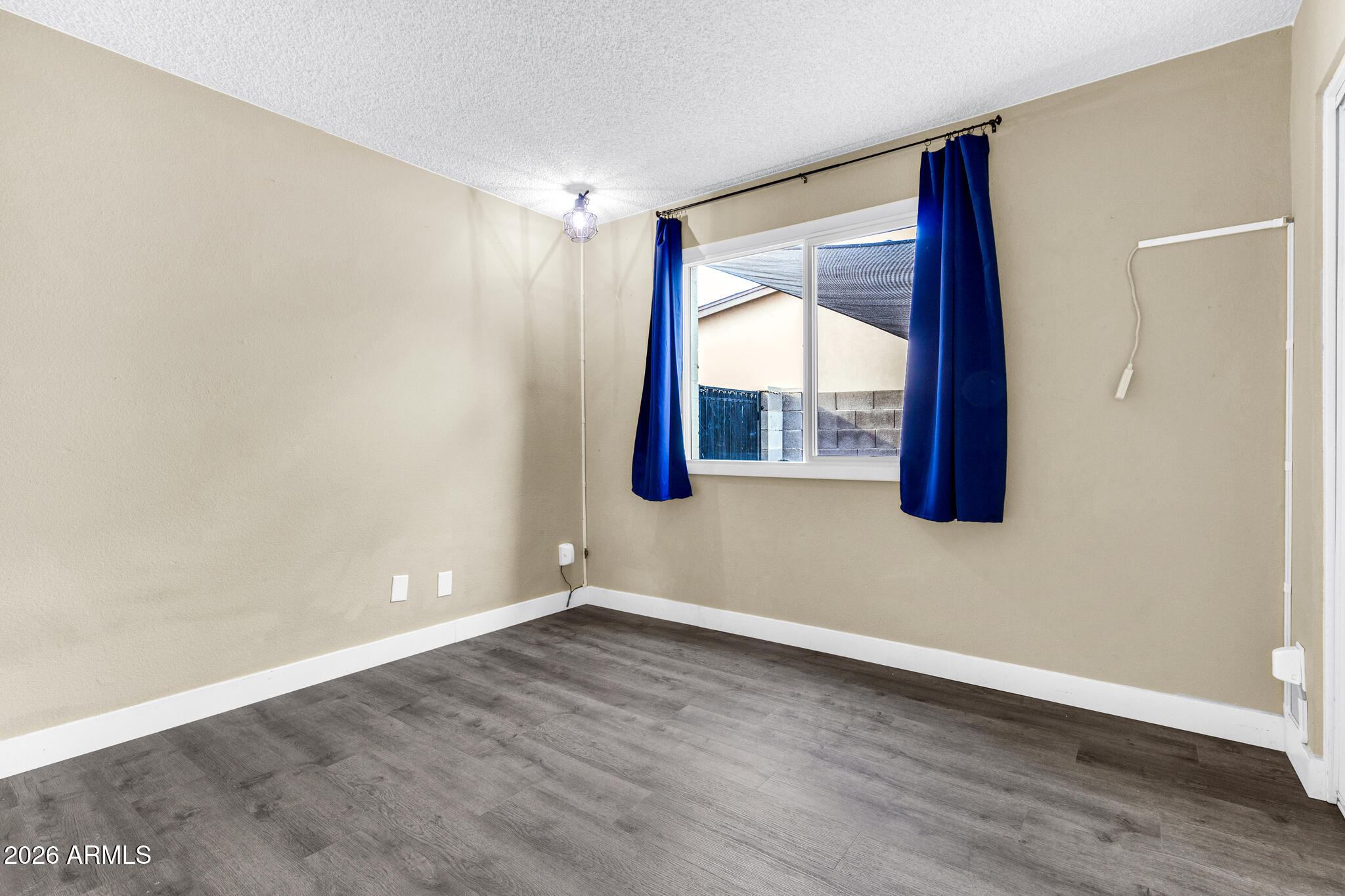 2024 East Rice Drive Tempe, AZ 85283 - Photo 26 of 39 a view of an empty room with wooden floor and a window