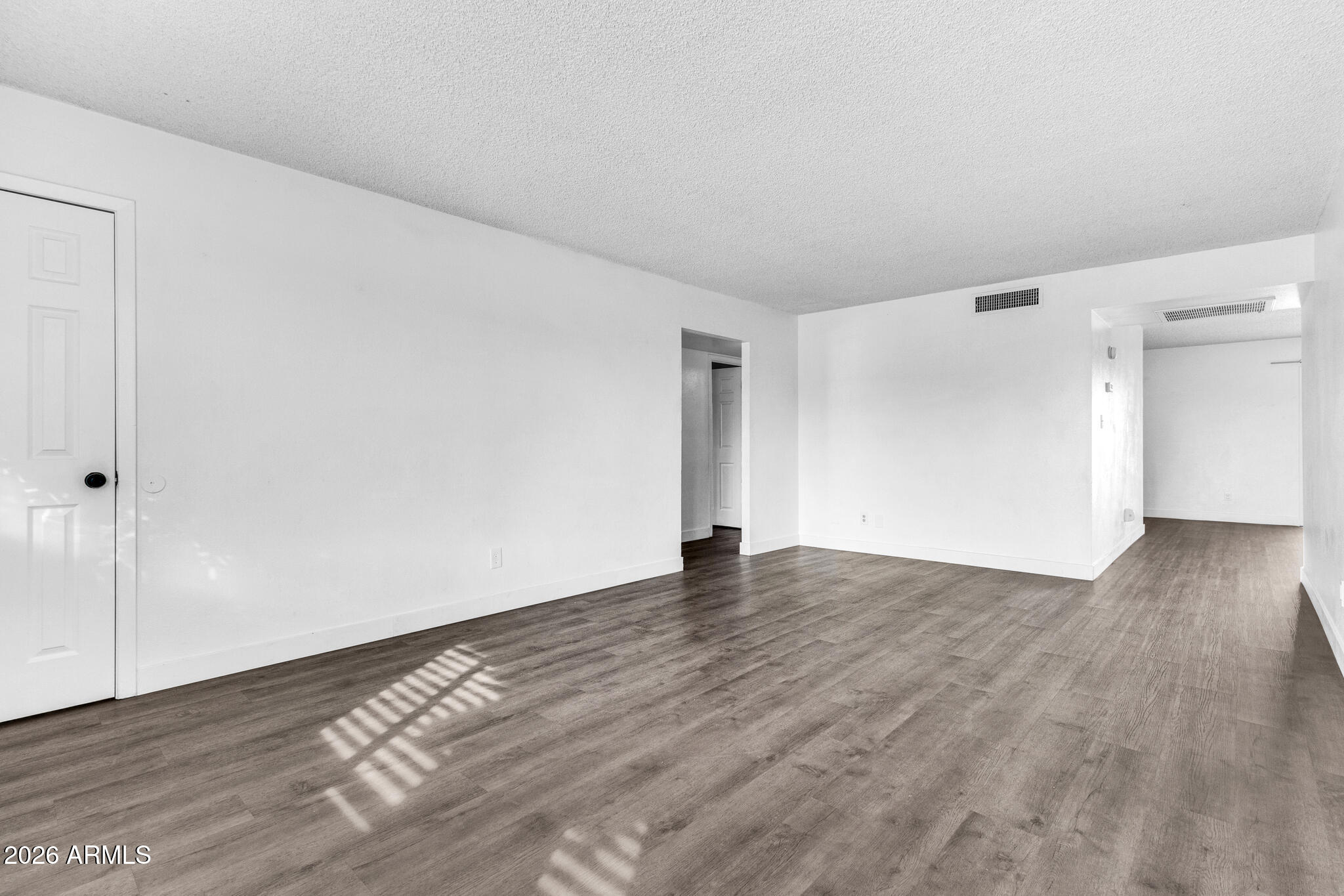 2024 East Rice Drive Tempe, AZ 85283 - Photo 6 of 39 a view of an empty room with wooden floor and a window