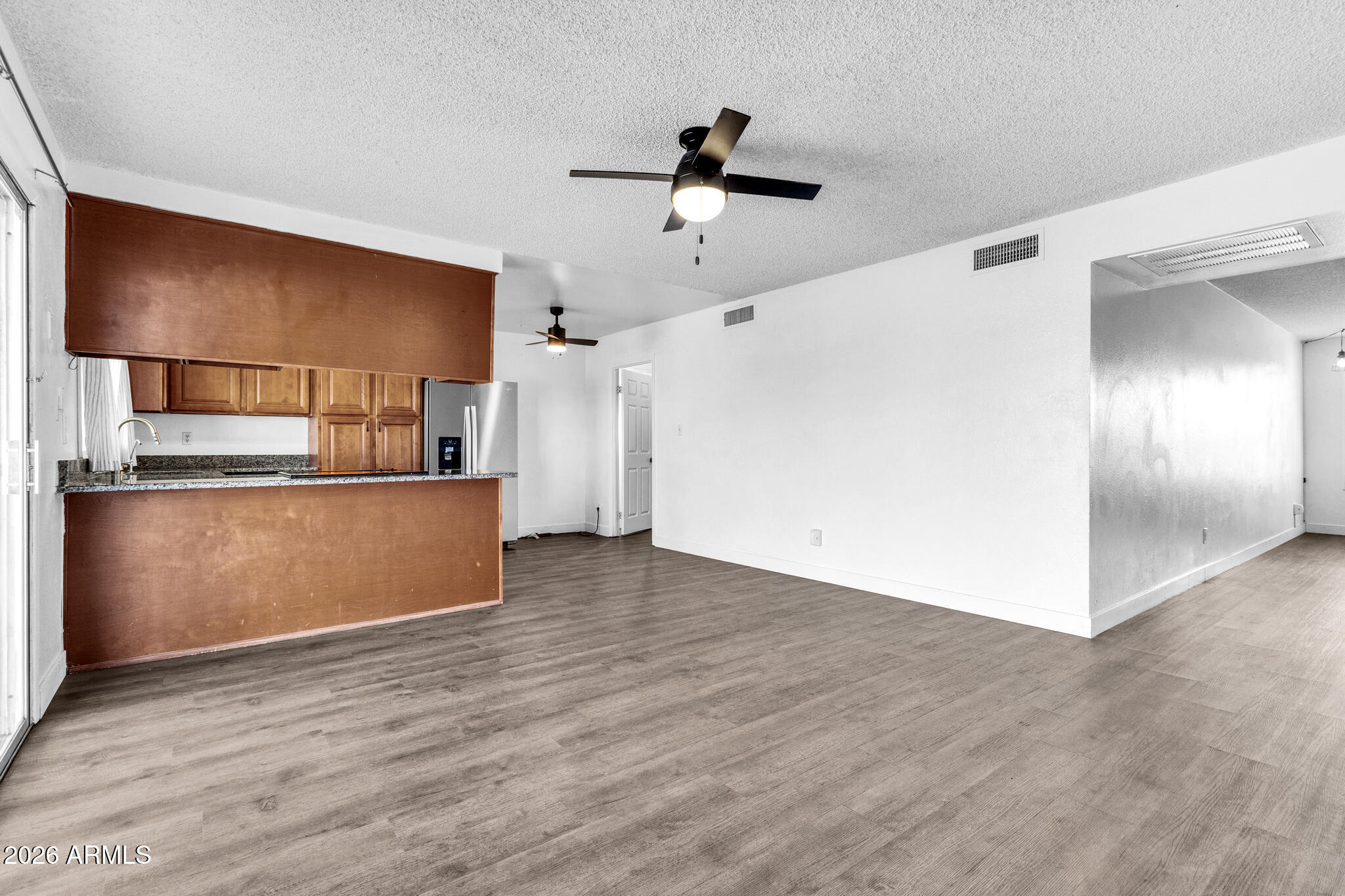 2024 East Rice Drive Tempe, AZ 85283 - Photo 10 of 39 a view of a kitchen with wooden floor and a ceiling fan